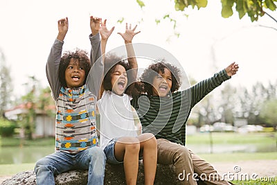 Happy African american little boy kids children joyfully cheerful and laughing. Concept of happiness. Stock Photo