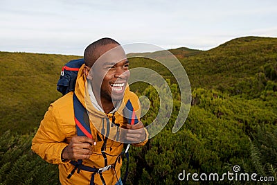 Happy african american male backpacker walking in nature Stock Photo