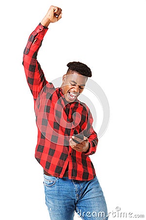 Happy african american man looking at phone and cheering with arm raised Stock Photo