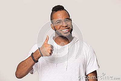 Happy African American man showing thumbs up gesture, satisfied client Stock Photo