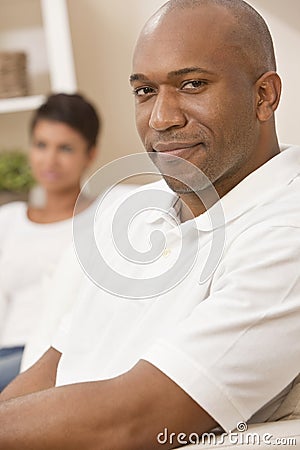 Happy African American Man Sitting At Home Stock Photo