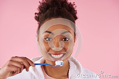 Happy African American woman brushes teeth. Stock Photo