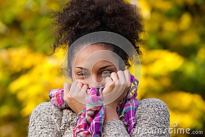 Happy african american woman posing with sweater and scarf Stock Photo