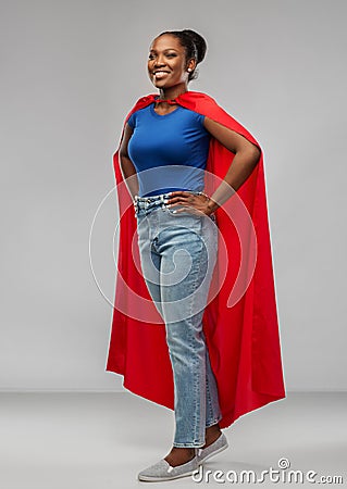 Happy african american woman in red superhero cape Stock Photo