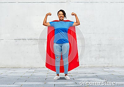 Happy african american woman in superhero red cape Stock Photo