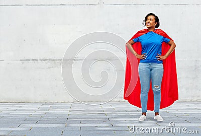 Happy african american woman in superhero red cape Stock Photo