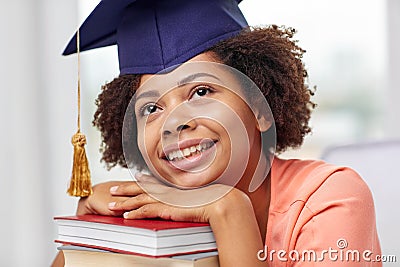 Happy african bachelor girl with books at home Stock Photo