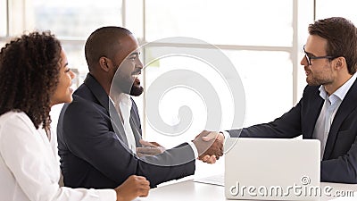 Happy african couple shake hand of insurer buy insurance services Stock Photo