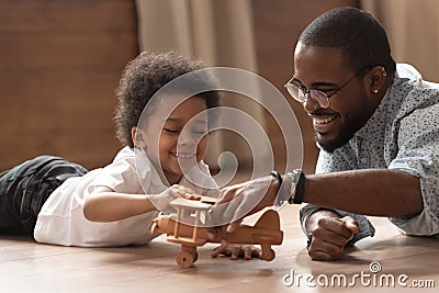 Happy african dad and child boy play with toy plane Stock Photo