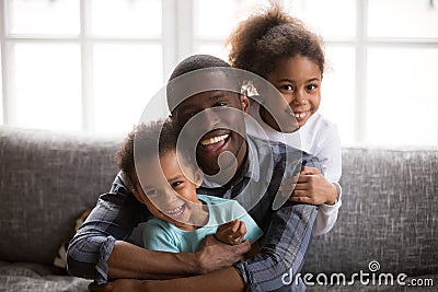 Happy african dad and mixed race children at home portrait Stock Photo