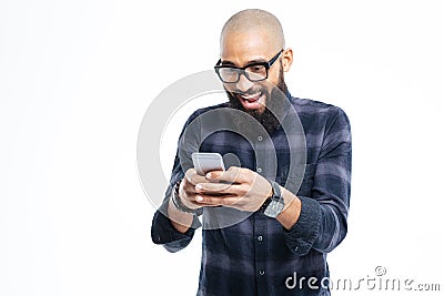 Happy african man with beard smiling and using mobile phone Stock Photo