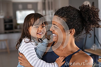 Lovely black mother carrying cute little daughter Stock Photo