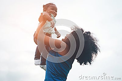 Happy african mother playing with her daughter outdoor - Afro mum and child having fun together - Family, happiness and love Stock Photo
