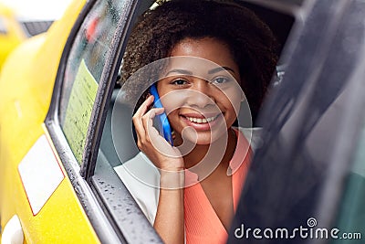 Happy african woman calling on smartphone in taxi Stock Photo