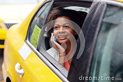 Happy african woman calling on smartphone in taxi Stock Photo