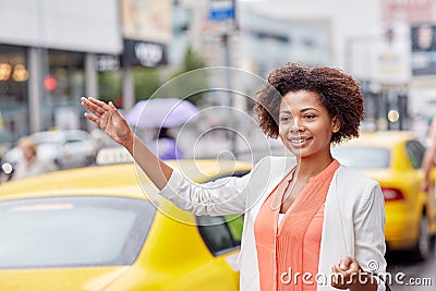 Happy african woman catching taxi Stock Photo