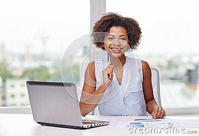 Happy african woman with laptop at office Stock Photo