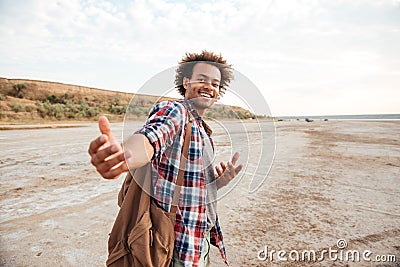 Happy african young man inviting you to go with him Stock Photo