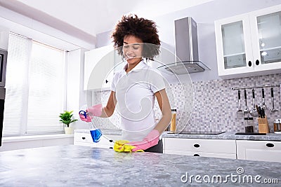 African Woman Cleaning Kitchen Counter Stock Photo