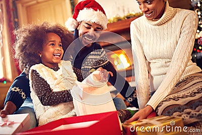 Happy Afro-American family opening Christmas presents Stock Photo