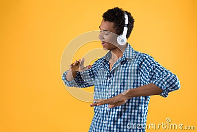 Happy Afro American teenager in headphones dancing Stock Photo