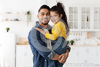 Happy Arab Dad Holding And Embracing With His Little Daughter At Home Stock Photo