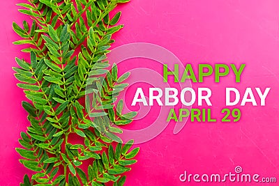 Happy Arbor Day April 29 with green leaf on pink Stock Photo