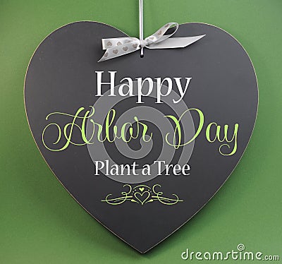 Happy Arbor Day, Plant a Tree, greeting message sign on heart shaped blackboard Stock Photo