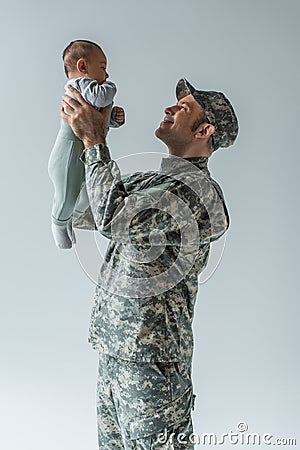 happy army soldier in uniform holding Stock Photo