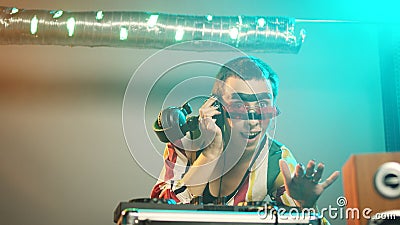 Happy artist working as dj with electric turntables Stock Photo