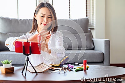 Blogger woman recording review comsmetic video at home Stock Photo
