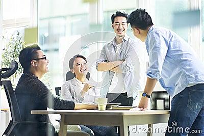 Happy asian business team meeting in office Stock Photo