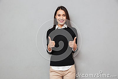 Happy asian business woman in business clothes showing thumbs up Stock Photo