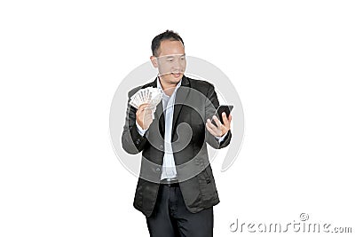 Happy asian businessmen holding banknotes and looking at his cellphone Stock Photo