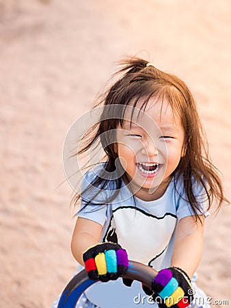 Happy Asian child on a seesaw Stock Photo