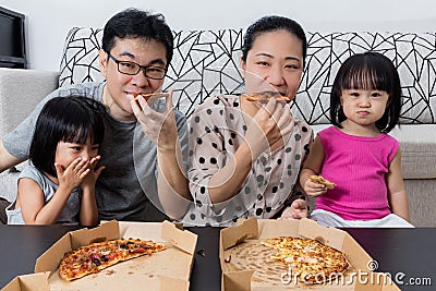 Happy Asian Chinese Family Eating Pizza Together Stock Photo