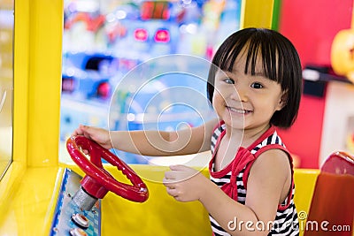 Happy Asian Chinese Little Girl Driving Toy Bus Stock Photo