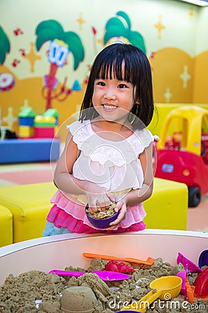 Happy Asian Chinese Little Girl Playing Kinetic Sand Indoor Stock Photo