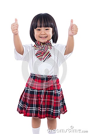 Happy Asian Chinese little student girl showing thumbs up Stock Photo