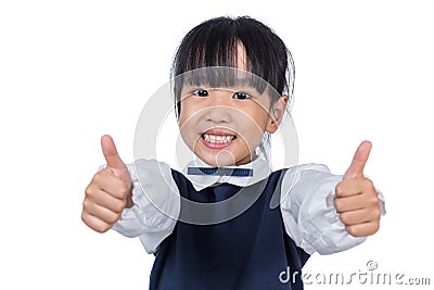 Happy Asian Chinese little student girl showing thumbs up Stock Photo