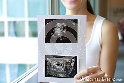 Happy Asian Chinese Woman smiling sweetly from pregnancy news Stock Photo