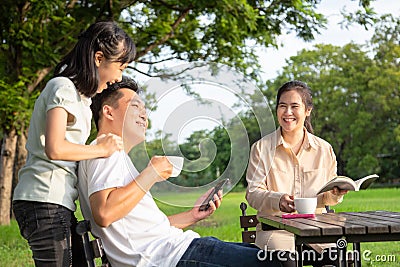 Happy asian family,little child girl or daughter enjoy,father talk,fun together,parents drink coffee or tea in the morning,smiling Stock Photo