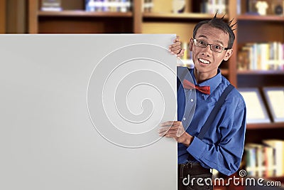 Happy asian nerdy man showing blank white board for copyspace Stock Photo