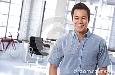 Happy asian office worker at trendy workplace Stock Photo