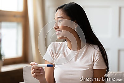 Happy Asian woman get positive ovulation test results Stock Photo