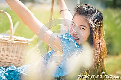 Happy Asian woman having relax time on a swing in nature field for nature hapiness lifestyle Stock Photo