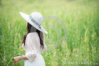 Happy asian woman lifestyle in the meadow yellow flower sunrise. Active Outdoor Relax and enjoy Stock Photo