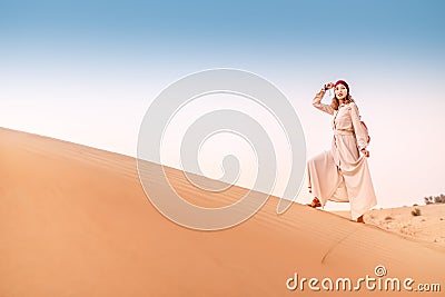 Asian woman in turban travels in Sahara desert. Adventure and life experience concept Stock Photo