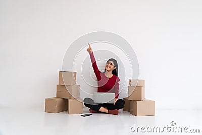 Happy Asian young entrepreneur, Smile for sales success and pointing finger up at the home office and store, Concept of merchant Stock Photo