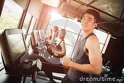 Happy asian young man with group of young people running Stock Photo